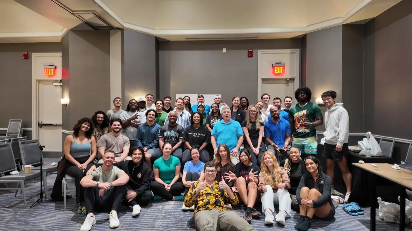 Podcast A seminar group of about forty five practitioners gathered for a photograph in a hotel ballroom.