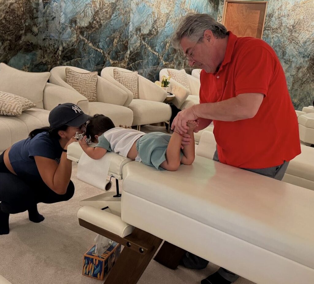 Dr. Mark Dulberg adjusting a young child at Luxury Chiropractic in North Miami Beach